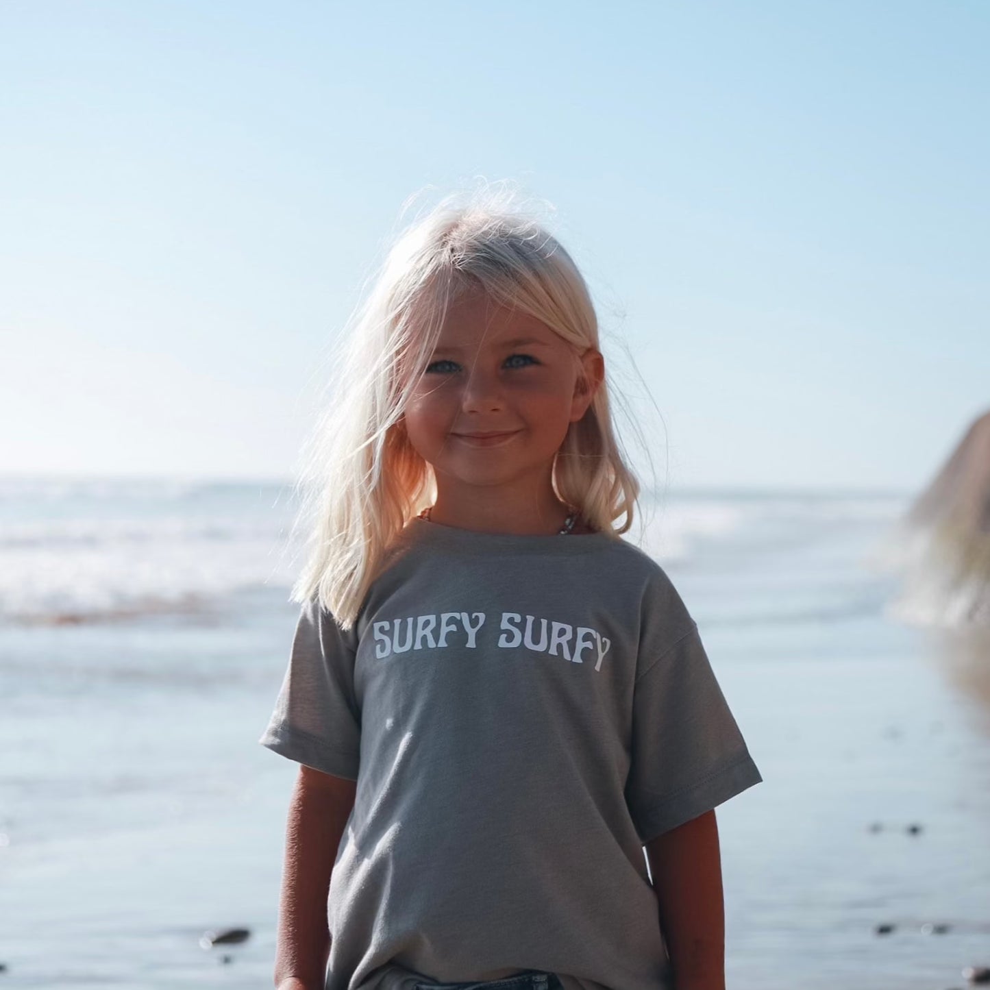 Girl wearing grey Surfy Surfy T-Shirt on beach